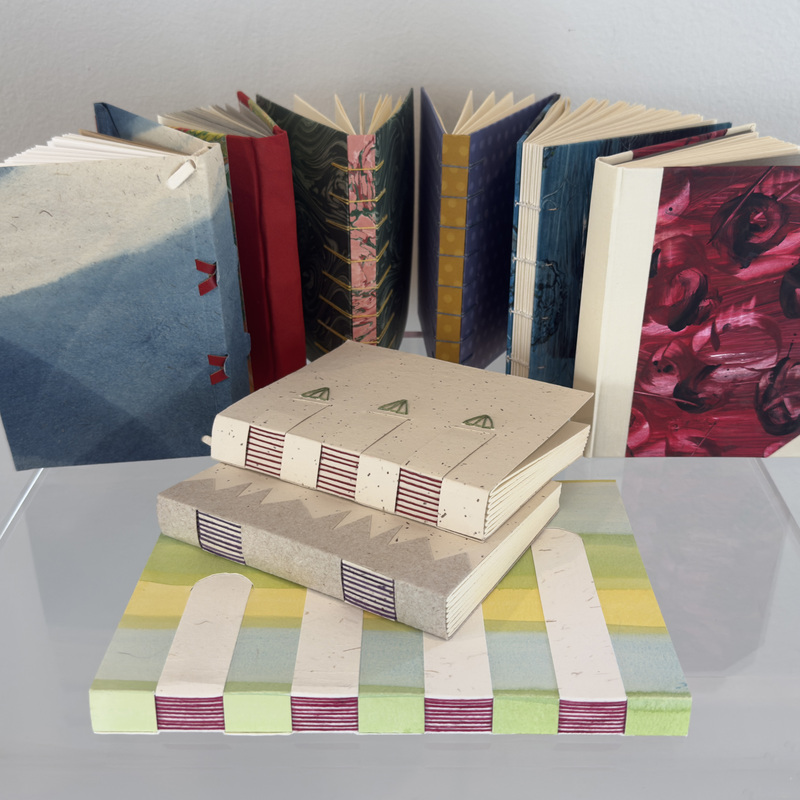 Hand-bound books. Paper, book board, linen thread and glue.